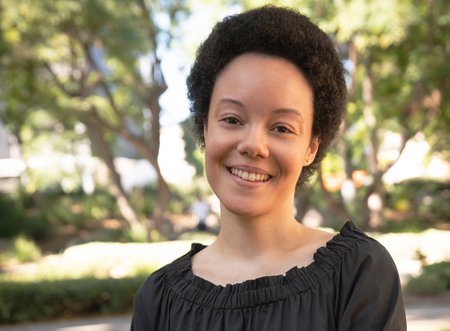 A portrait of Dana Murphy. Trees can be seen in the background.