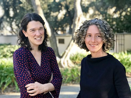 A portrait of professors Dehn Gilmore and Hillary Mushkin in a garden with trees