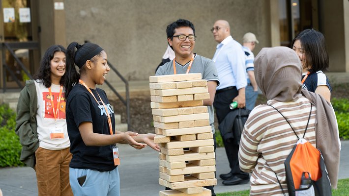 Students play a game of giant Jenga at DiscoTech