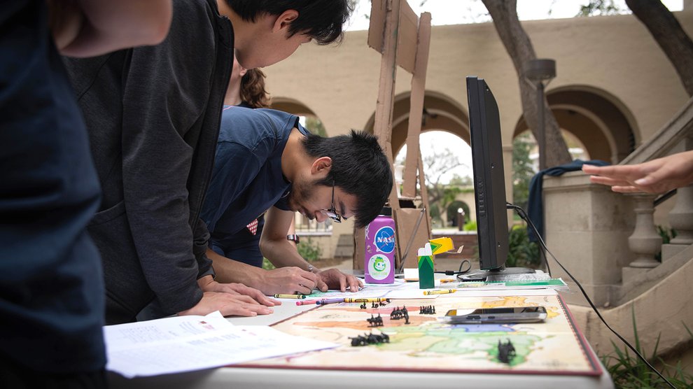 Students in the "Proceeding to the Before" stack color in a map with crayons to solve a puzzle.