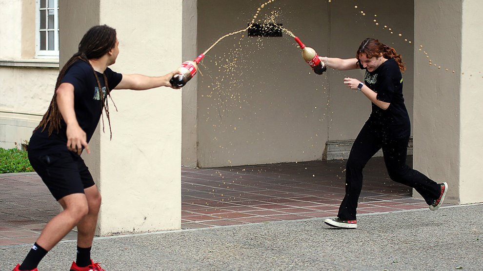 Students test exploding Coke bottles in a Mythbusters-themed stack.