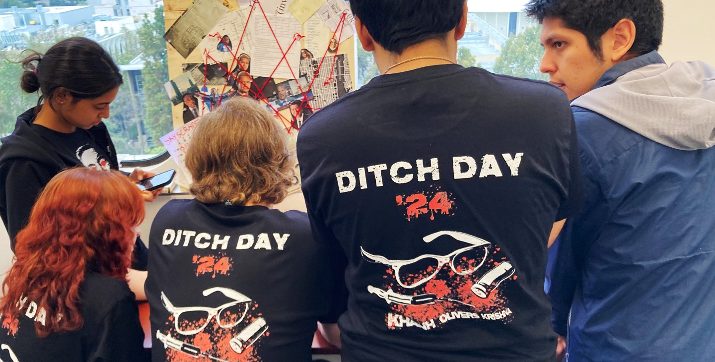 Students facing away from the camera with shirts that read "Ditch Day 2024" on the back