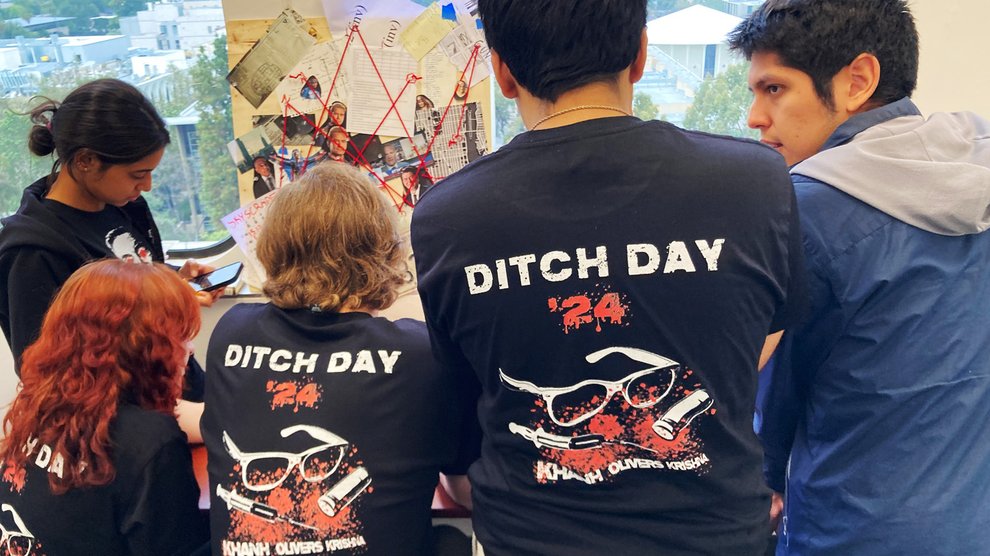 Students facing away from the camera with shirts that read "Ditch Day 2024" on the back