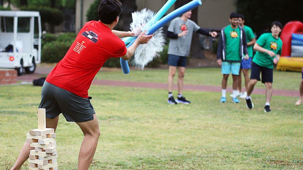 A student defends a Jenga tower against water ballons in a Cars themed stack.