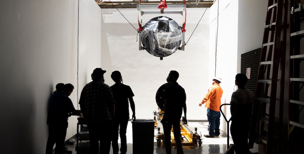 SPHEREx hardware being lowered into a basement lab.
