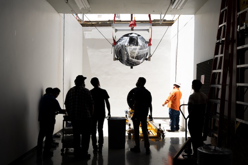 SPHEREx hardware being lowered into a basement lab.