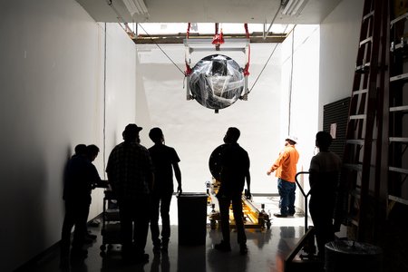 SPHEREx hardware being lowered into a basement lab.