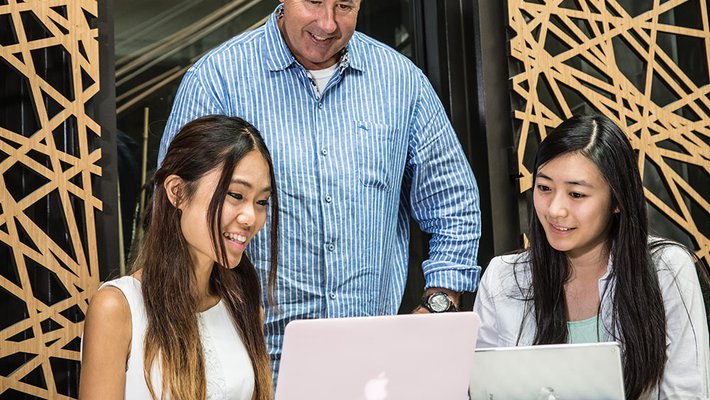 photo of two SURF students with a professor