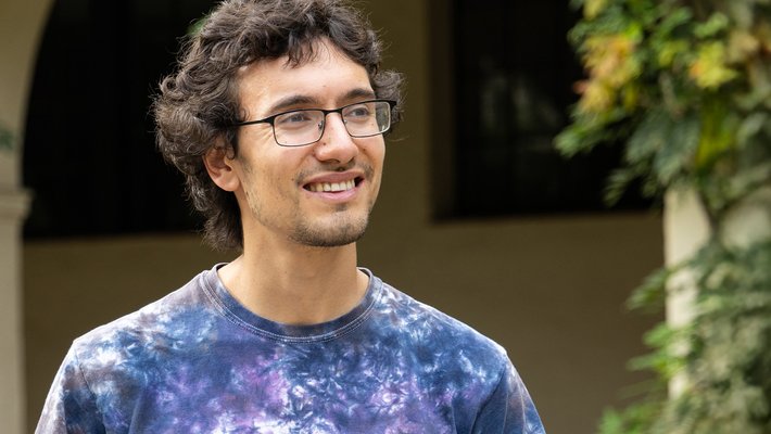 Kareem wears a tie-dye shirt outside.