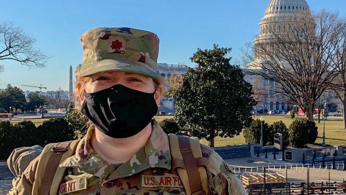 Woman in military uniform posed in front of U.S. Capitol.