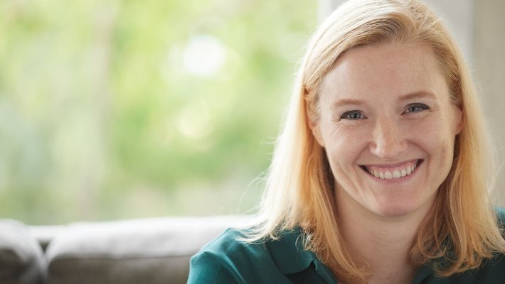 Eve Andersson wearing a green shirt in front of a soft-focus background