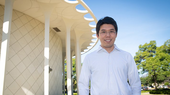 Image of professor Wei Gao in front of Beckman Auditorium