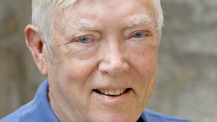 A portrait of David Grether. He smiles at the camera and wears a blue polo shirt.