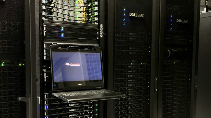 Stack of computers in a tall black case with a column of glowing lights.