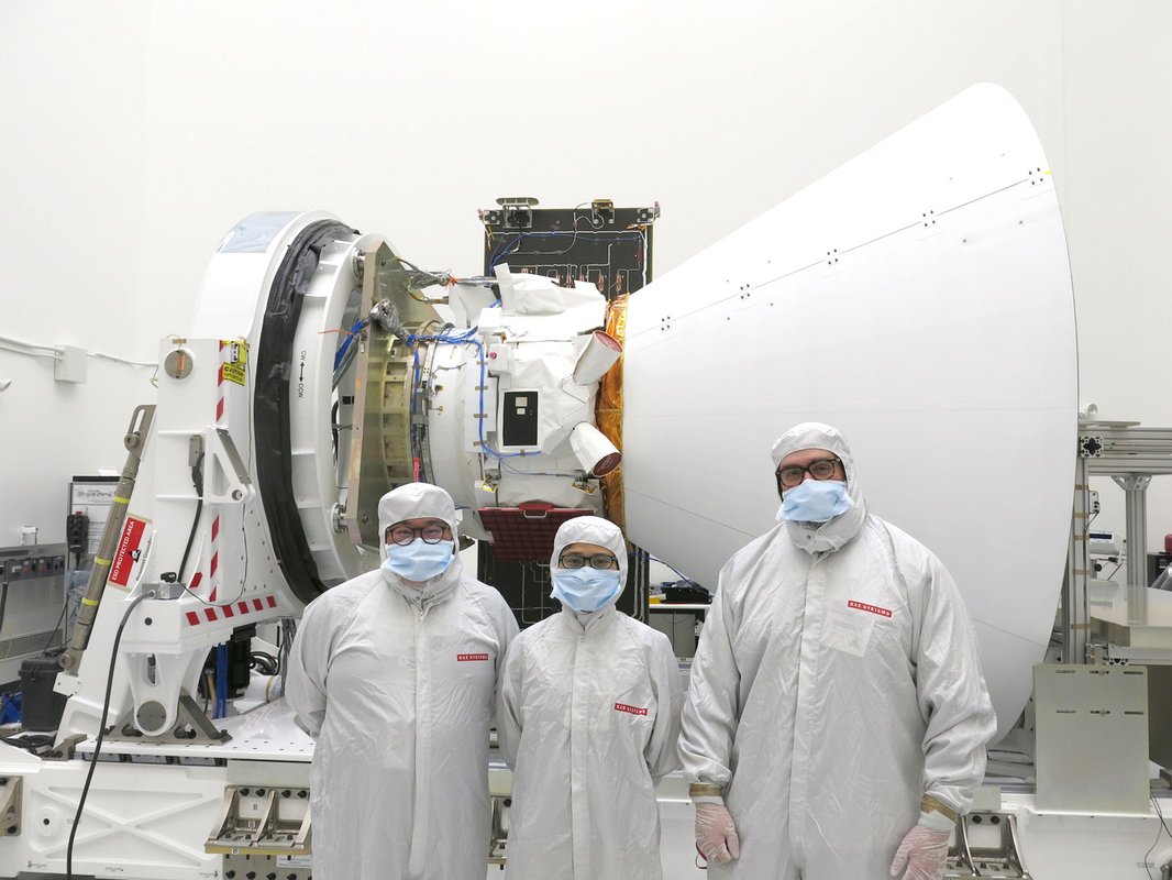 The team in front of spacecraft.