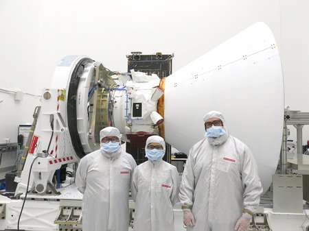 The team in front of spacecraft.