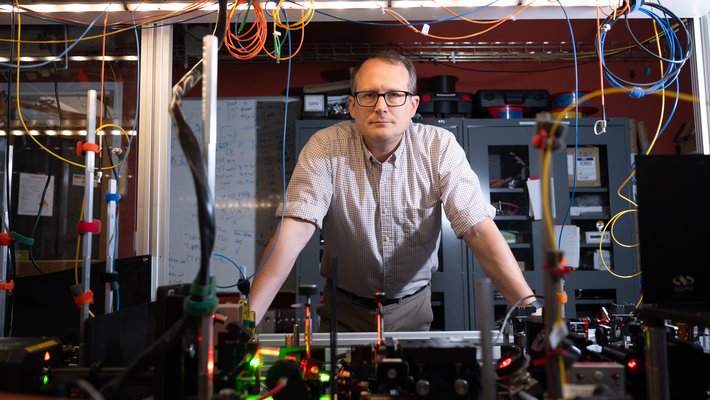 Image of Nick Hutzler leaning on lab equipment