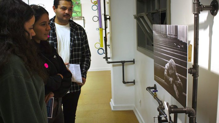 Guests at the October 13 Pasadena ArtNight at the Armory Center for the Arts view an untitled photo by Caltech graduate student Pooya Vahidi.