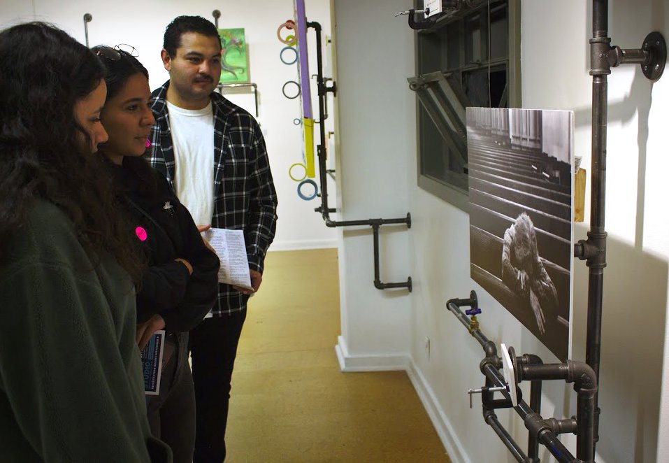 Guests at the October 13 Pasadena ArtNight at the Armory Center for the Arts view an untitled photo by Caltech graduate student Pooya Vahidi.