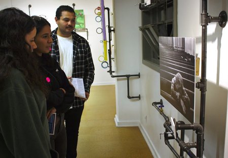 Guests at the October 13 Pasadena ArtNight at the Armory Center for the Arts view an untitled photo by Caltech graduate student Pooya Vahidi.