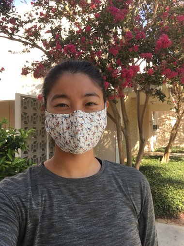 Outdoor selfie of student Renee Wang in a floral face covering