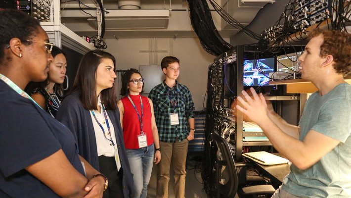 Graduate student Adam Shaw talks to prospective graduate students