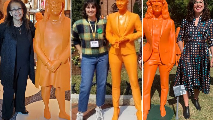 Three Caltech women next to orange statues