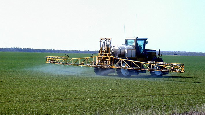 Fertilizer is applied to an agricultural field.