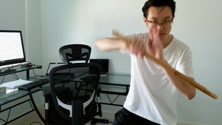Student Jaeyoung Kang in his apartment practicing Filipino Martial Arts