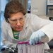 Professor Julia Kornfield examines laboratory equipment.