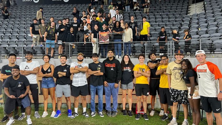 Students pose for a photo in the stadium after the LAFC match