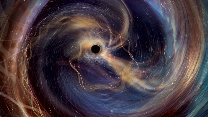 Swirling, colorful, wisps of gas surround a black hole.