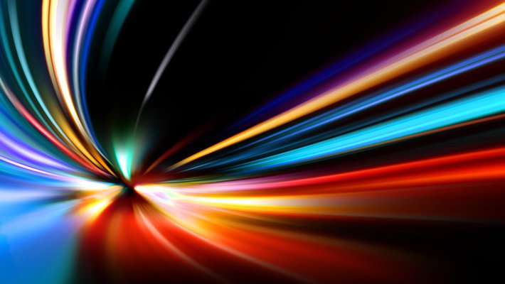 Streaky colored lights appear to zoom toward the viewer against a black background