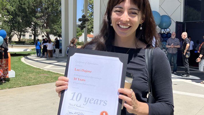 Lori DaJose holding her 10-year certificate at the 2025 Caltech's Staff Service & Impact Awards