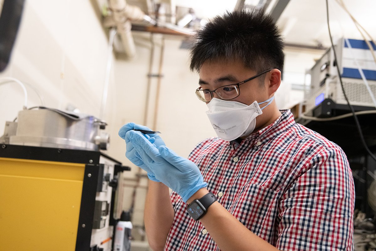 Chen-Hsuan (Steve) Lu inspects a substrate coated in graphene.