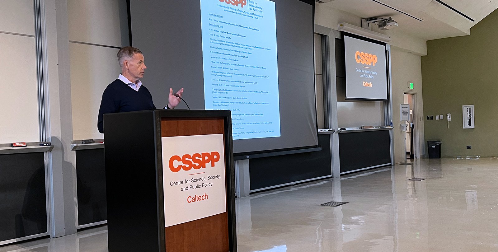 Michael Alvarez at the podium of a conference.