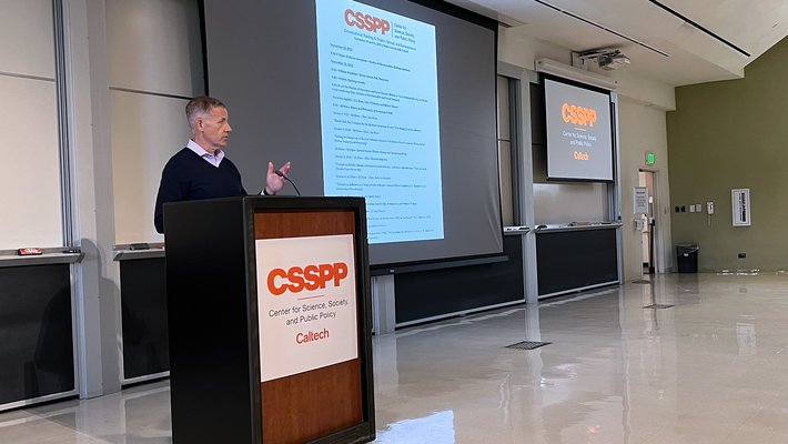 Michael Alvarez at the podium of a conference.