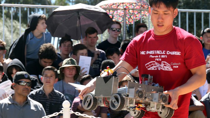 Kyung Park, of Team Soul, places a robot for one of the early heats.