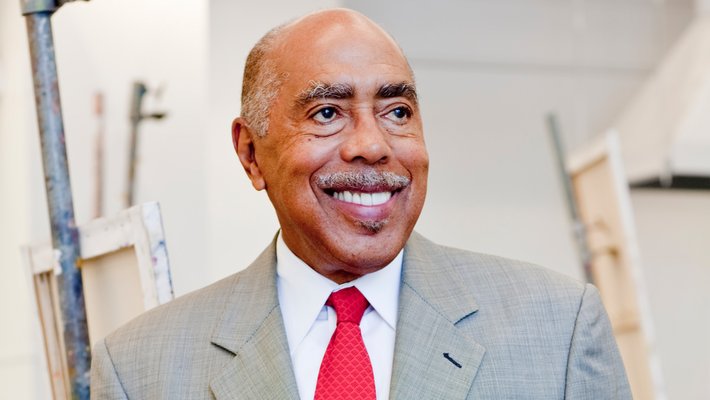 Image of a man in a suit looking off-camera