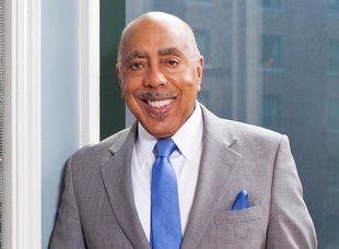 Walter Massey looking at the viewer