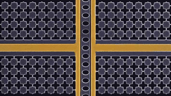 black and white microscope image of a mechanical oscillator with two false-colored vertical golden lines and one horizontal