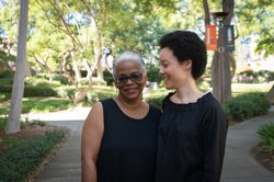A portrait of Dana Murphy and her mom, Marta Murphy. Marta Murphy looks at the camera. Dana looks at her mom and smiles.