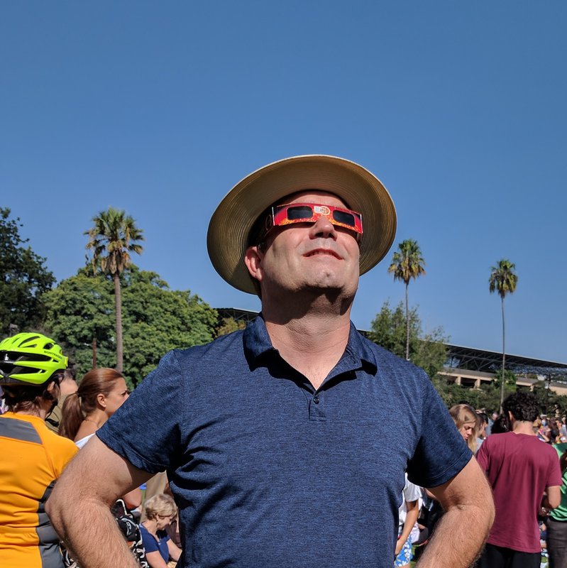 Mueller, a senior gift planning officer in the Office of Gift Planning, views the recent eclipse on campus. 