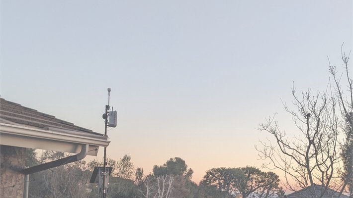 View of mountains from a rooftop with an air sensor installed