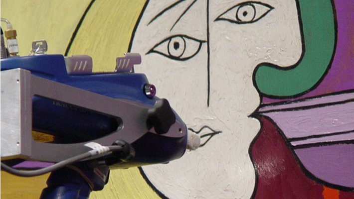 Scanning an oil painting with an X-ray fluorescence spectrometer.