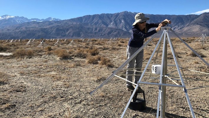 Kathryn Plant (PhD '23) setting up an antenna in the desert