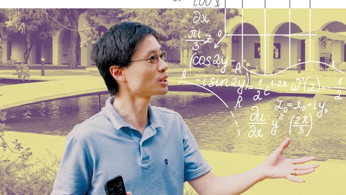 Man in glasses wearing a blue polo shirt, surrounded by equations