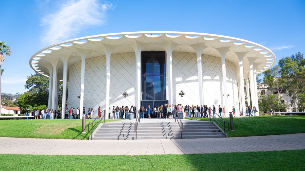 Children line up, waiting to enter an auditorium