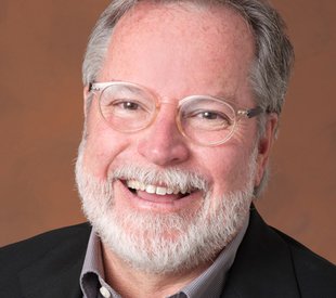 A portrait of Rob Manning smiling at the camera.