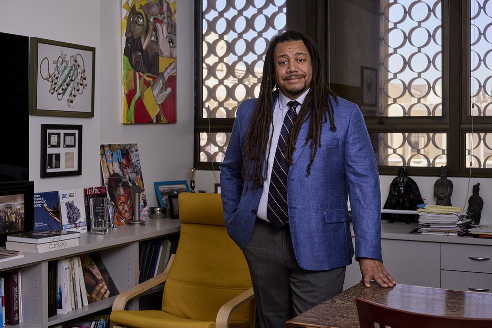 Image of Bil Clemons in blue suit and tie in office